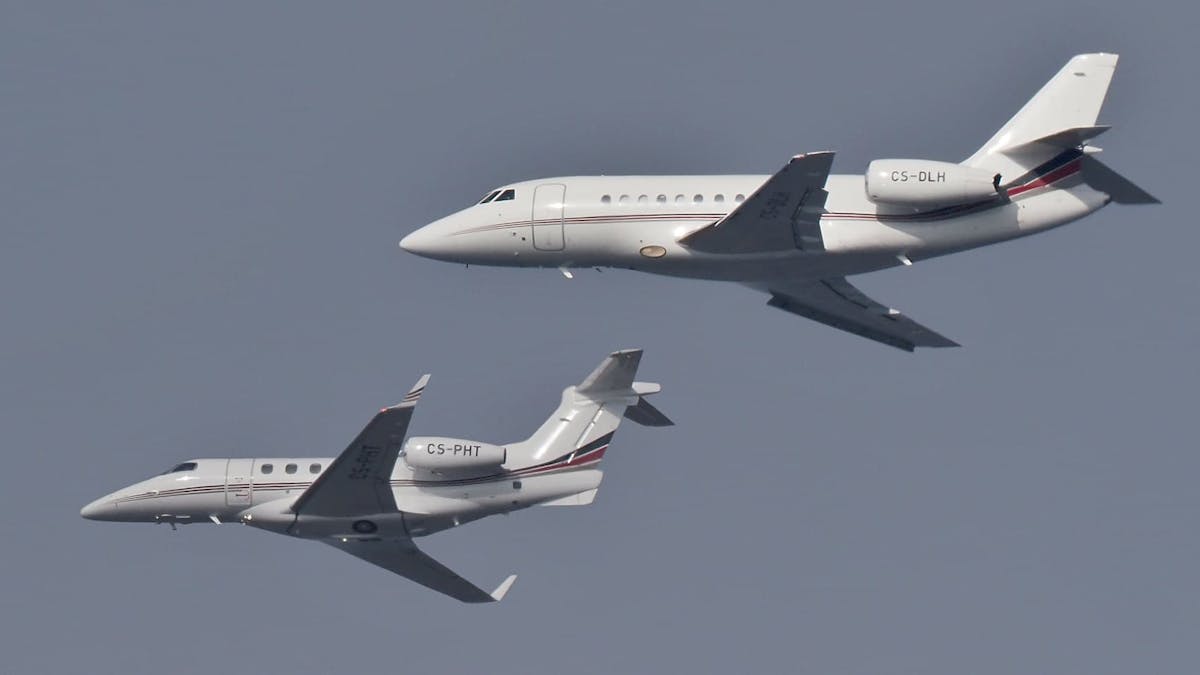Two white private jets photoshopped flying next to eachother.